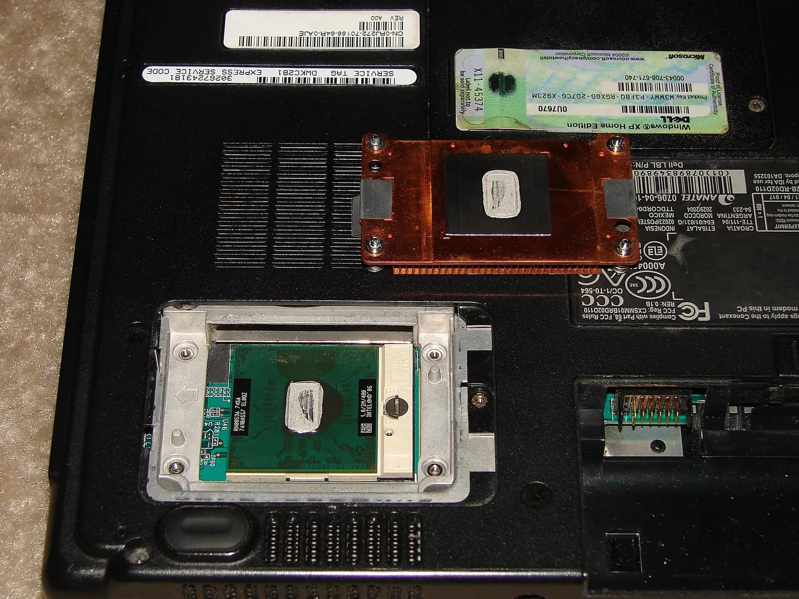 Laptop with its base removed, showing the processor and copper heat pipe